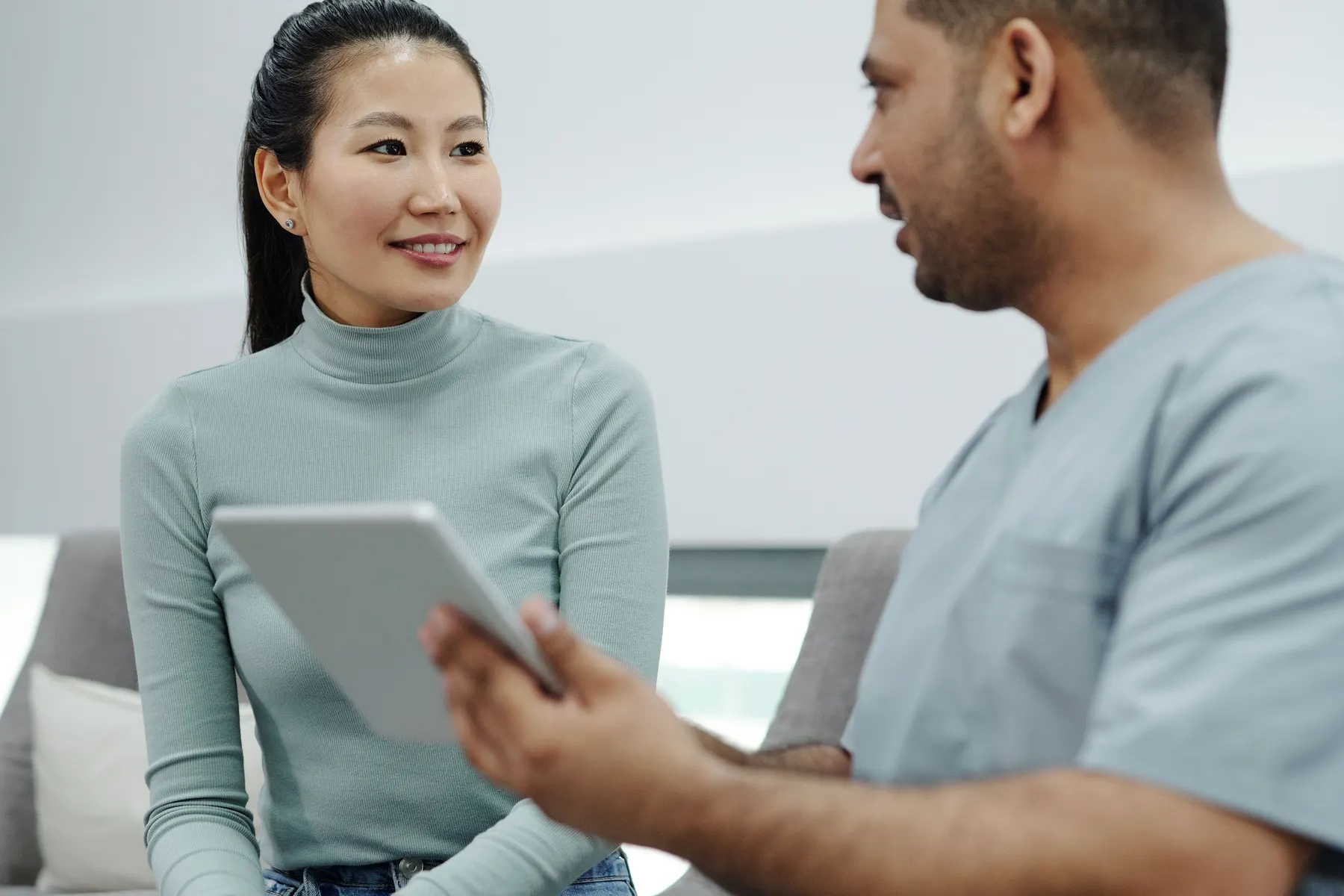 A healthcare professional speaking with a patient during a clinic visit.